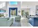 Bright living room with high ceilings, a blue patterned rug, comfortable seating and access to the pool area at 8462 Secret Key Cv, Kissimmee, FL 34747