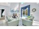 Inviting living room with high ceilings, comfortable seating, and a view of the pool area at 8462 Secret Key Cv, Kissimmee, FL 34747