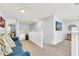 A cozy loft featuring a blue sofa, a railing, and art hanging on the light blue walls at 8462 Secret Key Cv, Kissimmee, FL 34747