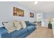 A bright loft space with blue sofa, light blue walls and a view of the stair rail at 8462 Secret Key Cv, Kissimmee, FL 34747