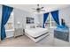 Bright main bedroom features a king bed, ceiling fan and two nightstands with bedside lamps at 8462 Secret Key Cv, Kissimmee, FL 34747