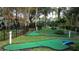 Fun-filled mini golf course surrounded by lush greenery and trees, perfect for Gathering entertainment at 8462 Secret Key Cv, Kissimmee, FL 34747
