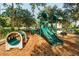 Community playground with slides, tunnels, and a cushioned ground, providing a safe and fun play area at 8462 Secret Key Cv, Kissimmee, FL 34747