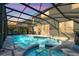 Beautiful screened-in pool with an outdoor dining table at 8462 Secret Key Cv, Kissimmee, FL 34747