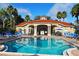Beautiful community pool surrounded by lounge chairs and lush landscaping, perfect for relaxation and recreation at 8462 Secret Key Cv, Kissimmee, FL 34747