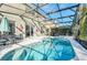 Screened-in pool and spa with sun loungers and dining set at 8462 Secret Key Cv, Kissimmee, FL 34747
