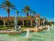 Stunning water feature at the resort's entrance with dolphin statues, fountains, and palm trees at 8462 Secret Key Cv, Kissimmee, FL 34747