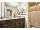 Bathroom with a double vanity, granite countertop, and shower with curtain at 8908 Adriatico Ln, Kissimmee, FL 34747