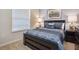 Cozy bedroom with a large window, stylish bedding, and bedside tables with lamps at 8908 Adriatico Ln, Kissimmee, FL 34747