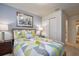 Bright bedroom with a large window, lamps on nightstands and a colorful quilt on the bed at 8908 Adriatico Ln, Kissimmee, FL 34747