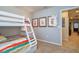 Bedroom with a bunk bed, cartoon artwork, and doorway to another room at 8908 Adriatico Ln, Kissimmee, FL 34747