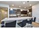 Stylish kitchen showcasing dark cabinets, granite countertops, pendant lighting, and bar seating at 8908 Adriatico Ln, Kissimmee, FL 34747