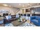Modern living room features a leather sofa, breakfast bar, and staircase at 8908 Adriatico Ln, Kissimmee, FL 34747