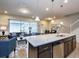 Open-concept living area with granite island, and comfortable seating at 8908 Adriatico Ln, Kissimmee, FL 34747