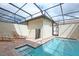 Screened-in pool area with brick pavers, lounge chairs, and hot tub at 8908 Adriatico Ln, Kissimmee, FL 34747