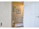 Powder room with white fixtures and coastal-themed art at 8908 Adriatico Ln, Kissimmee, FL 34747