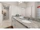 Bright bathroom with granite countertops, a double sink, a closet, and a clean, functional design at 8982 Shine Drive, Kissimmee, FL 34747