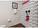 Modern bathroom featuring a Mickey Mouse-themed shower curtain, adding a touch of fun to the functional space at 8982 Shine Drive, Kissimmee, FL 34747