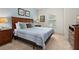 Inviting bedroom showcasing a queen-sized bed, soft carpet, natural light and neutral-colored walls, creating a relaxing space at 8982 Shine Drive, Kissimmee, FL 34747