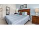 Inviting bedroom showcasing a queen-sized bed, soft carpet, neutral-colored walls, and wooden accents for a cozy retreat at 8982 Shine Drive, Kissimmee, FL 34747