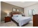 Comfortable bedroom with a plush bed, decorative pillows, and warm, inviting lighting at 8982 Shine Drive, Kissimmee, FL 34747