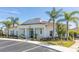 Inviting clubhouse featuring a covered entry, mature landscaping, and convenient parking at 8982 Shine Drive, Kissimmee, FL 34747