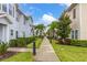 Charming community street view showcasing well-manicured lawns, sidewalks, and beautifully maintained townhomes at 8982 Shine Drive, Kissimmee, FL 34747