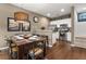 Chic dining area with a wooden table, chairs, and a view of the well-equipped kitchen at 8982 Shine Drive, Kissimmee, FL 34747