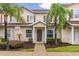 Inviting townhome featuring a warm-toned facade, well-kept landscaping, and a welcoming front entrance at 8982 Shine Drive, Kissimmee, FL 34747