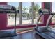 Modern gym featuring treadmills overlooking the community pool, blending fitness and leisure at 8982 Shine Drive, Kissimmee, FL 34747