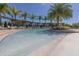 Picturesque community pool featuring a zero entry section and plenty of seating at 8982 Shine Drive, Kissimmee, FL 34747