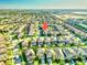 Expansive aerial view of a residential community with well-maintained lawns and houses, showcasing the neighborhood layout at 9156 Wedge Dr, Davenport, FL 33896