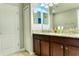Bathroom featuring double sinks with granite countertops and dark wood cabinets at 9156 Wedge Dr, Davenport, FL 33896