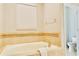 Elegant bathroom with a soaking tub, tiled surround, and modern fixtures at 9156 Wedge Dr, Davenport, FL 33896