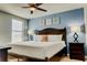 Comfortable bedroom with three decorations and a ceiling fan, with a blue accent wall at 9156 Wedge Dr, Davenport, FL 33896