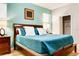 Bright bedroom with a wooden bed frame, blue bedding, and stylish decorations with a walk in closet at 9156 Wedge Dr, Davenport, FL 33896