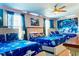 Fun, Star Wars themed bedroom featuring three beds, bright artwork and blue colored lighting at 9156 Wedge Dr, Davenport, FL 33896