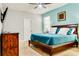 Bedroom with cool blue walls, nice furniture, a wooden bed frame and carpet at 9156 Wedge Dr, Davenport, FL 33896