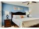 Comfortable bedroom with three decorations and a ceiling fan, with a blue accent wall at 9156 Wedge Dr, Davenport, FL 33896