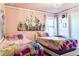 Charming bedroom featuring twin beds, a castle theme, and plenty of natural light at 9156 Wedge Dr, Davenport, FL 33896