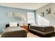 Comfortable bedroom featuring two twin beds, neutral walls and a window at 9156 Wedge Dr, Davenport, FL 33896