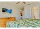 Bedroom with TV, green accents and dresser at 9156 Wedge Dr, Davenport, FL 33896