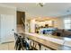 Open dining area with seating for ten and a view of the kitchen and stairway at 9156 Wedge Dr, Davenport, FL 33896