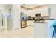 Bright kitchen featuring stainless steel appliances, ample counter space, and convenient bar seating at 9156 Wedge Dr, Davenport, FL 33896