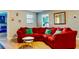 Comfortable living room with a large red sectional, unique wall decor, and views into the other bedrooms at 9156 Wedge Dr, Davenport, FL 33896