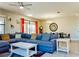 Bright and airy living room with a comfortable sofa, stylish decor, and a view into the dining area at 9156 Wedge Dr, Davenport, FL 33896