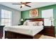 Spacious main bedroom featuring a ceiling fan, multiple windows, and dark wood furniture at 9156 Wedge Dr, Davenport, FL 33896