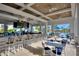 Inviting outdoor bar and dining area by the pool, featuring a bar with seating and tables for relaxing at 9156 Wedge Dr, Davenport, FL 33896