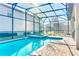 Enjoy Florida living with this screened in pool and outdoor seating at 9156 Wedge Dr, Davenport, FL 33896