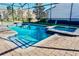 Sparkling pool with an attached spa and brick paver deck at 9156 Wedge Dr, Davenport, FL 33896